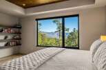 Experience breathtaking mountain views from this serene bedroom, featuring a large picture window that floods the space with natural light.