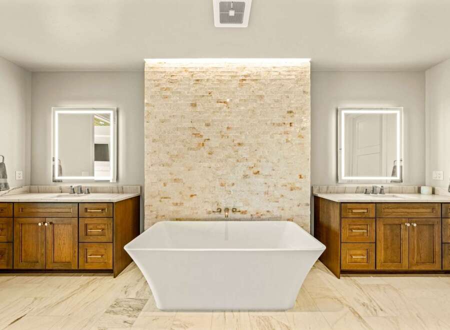 Experience luxury in this stunning master bathroom, featuring a freestanding soaking tub as the centerpiece.