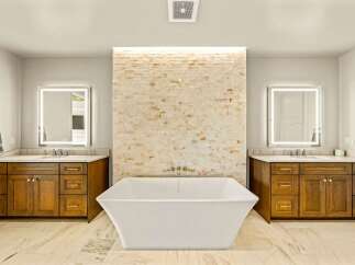 Experience luxury in this stunning master bathroom, featuring a freestanding soaking tub as the centerpiece.