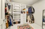 Step into this spacious walk-in closet, designed for ultimate organization and style.