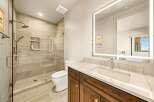 Experience modern luxury in this stunning bathroom, featuring a spacious walk-in shower with elegant tilework and a built-in niche for toiletries.