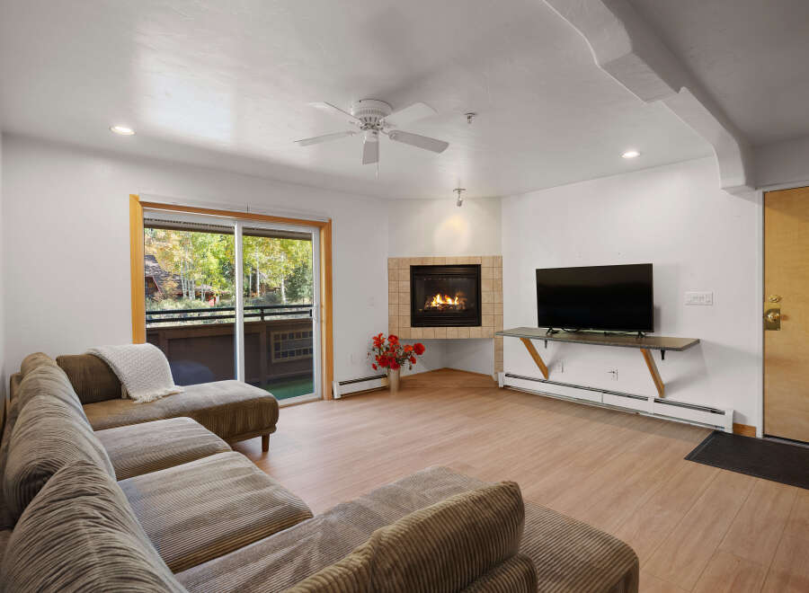 Cozy living room featuring a plush sectional sofa and a warm gas fireplace, perfect for relaxing evenings.