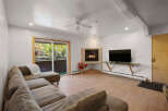 Cozy living room featuring a plush sectional sofa and a warm gas fireplace, perfect for relaxing evenings.