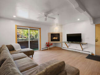 Cozy living room featuring a plush sectional sofa and a warm gas fireplace, perfect for relaxing evenings.
