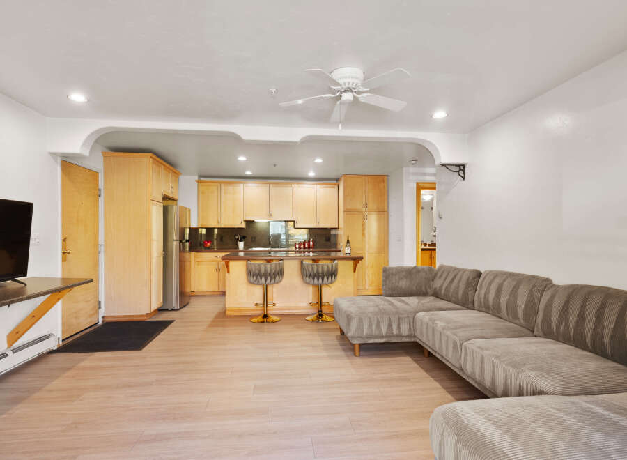 This open-concept living space features a modern sectional sofa perfect for relaxing and entertaining.