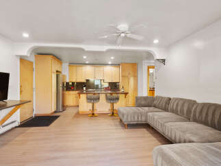 This open-concept living space features a modern sectional sofa perfect for relaxing and entertaining.