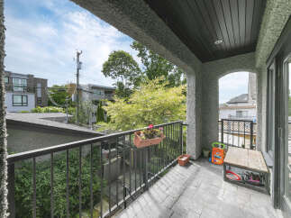 Enjoy outdoor living on this charming balcony, perfect for relaxing or entertaining.