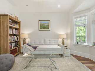 Step into this inviting living room, featuring a plush white sofa perfect for relaxation and a stylish glass coffee table.