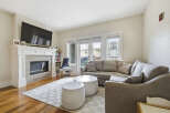 Experience modern living in this beautifully appointed living room, featuring a sleek fireplace and a large sectional sofa perfect for relaxation.