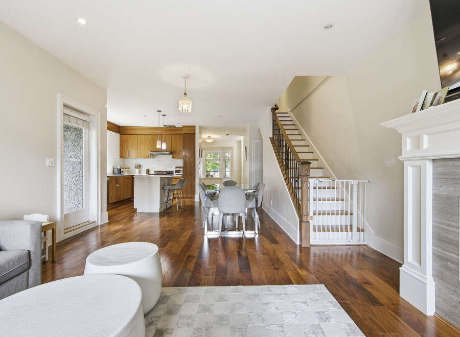 Discover this stunning open-concept living space featuring a modern kitchen with ample cabinetry and a central island, perfect for casual dining.