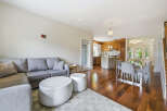 Experience modern living in this open-concept space featuring a comfortable sectional sofa and a sleek dining area.