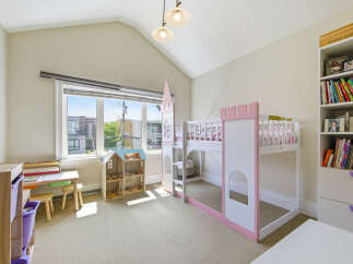 This charming children's bedroom features a whimsical castle-themed bunk bed, perfect for sparking imagination.
