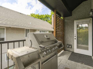 Enjoy outdoor living on this spacious balcony, perfect for entertaining guests.