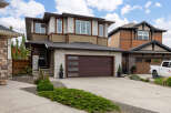 Discover modern living in this stunning two-story home featuring a striking stone and wood exterior.