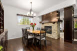 Experience elegant dining in this beautifully appointed space, featuring a live-edge wood dining table surrounded by six chairs.