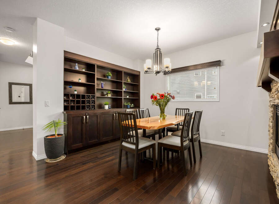 This dining room features a stunning live-edge wood dining table surrounded by dark wood chairs, perfect for intimate gatherings.