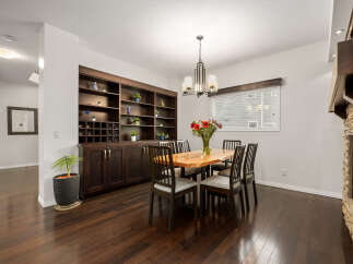 This dining room features a stunning live-edge wood dining table surrounded by dark wood chairs, perfect for intimate gatherings.