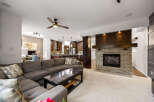Experience luxury living in this stunning open-concept home, featuring a modern living room with a cozy stone fireplace and a spacious sectional sofa.