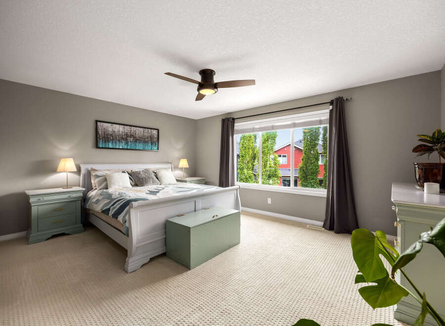 Experience comfort and style in this beautifully appointed bedroom, featuring a plush king-sized bed with a decorative duvet and accent pillows.