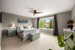 Experience comfort and style in this beautifully appointed bedroom, featuring a plush king-sized bed with a decorative duvet and accent pillows.