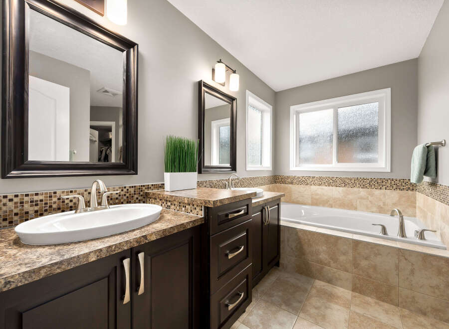 Indulge in this luxurious bathroom featuring a spacious soaking tub, perfect for unwinding after a long day.
