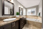 Indulge in this luxurious bathroom featuring a spacious soaking tub, perfect for unwinding after a long day.