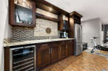 This home features a stylish wet bar area perfect for entertaining, complete with a wine fridge, sink, and ample cabinet space.