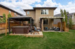 Enjoy ultimate relaxation in this backyard oasis, featuring a luxurious hot tub under a protective gazebo.