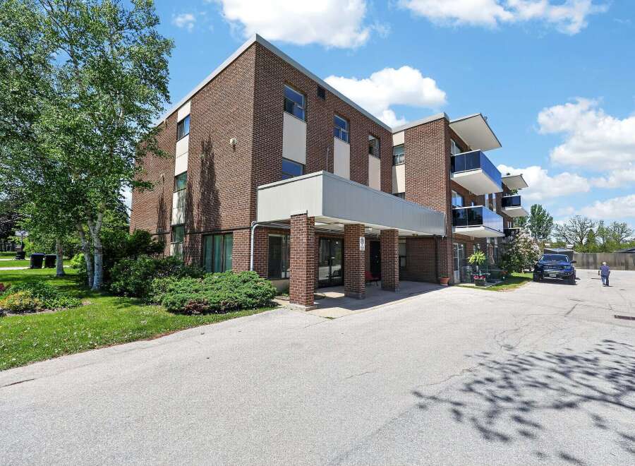 Discover modern living in this brick apartment building featuring sleek balconies with glass railings and ample natural light.