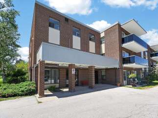 Discover comfortable living in this charming brick building, featuring modern balconies with sleek glass railings perfect for enjoying the outdoors.