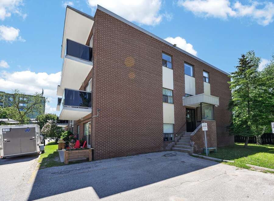 Discover comfortable living in this charming brick building, featuring modern balconies with glass railings perfect for enjoying the outdoors.
