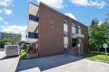 Discover comfortable living in this charming brick building, featuring modern balconies with glass railings perfect for enjoying the outdoors.