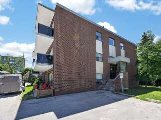 Discover comfortable living in this charming brick building, featuring modern balconies with glass railings perfect for enjoying the outdoors.