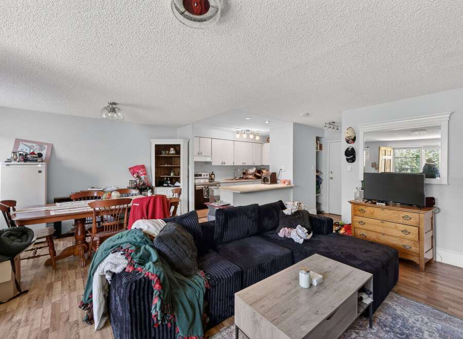 Discover a cozy living space featuring a spacious sectional sofa perfect for relaxation and entertainment.