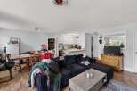 Discover a cozy living space featuring a spacious sectional sofa perfect for relaxation and entertainment.