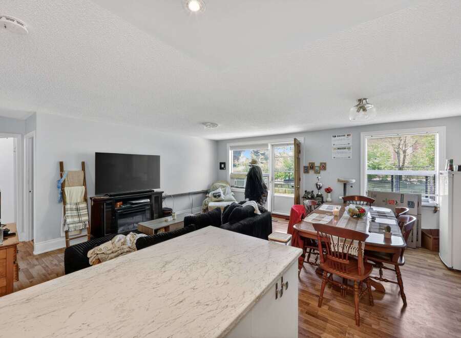 Discover comfortable living in this inviting space, featuring a spacious living area with a large TV and a cozy seating arrangement perfect for relaxation.