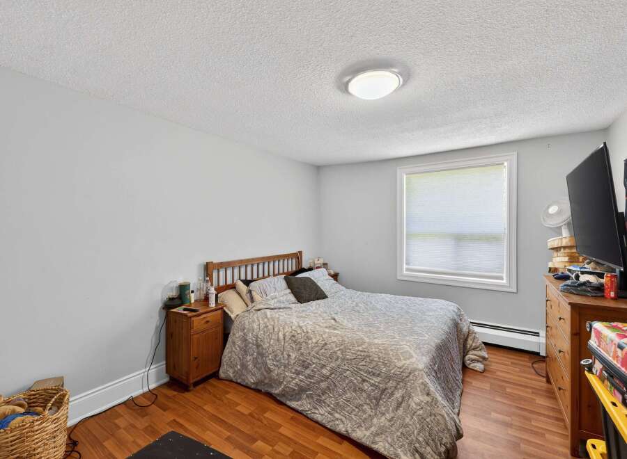 This cozy bedroom features a comfortable queen-size bed with a patterned comforter and a wooden headboard.