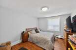 This cozy bedroom features a comfortable queen-size bed with a patterned comforter and a wooden headboard.