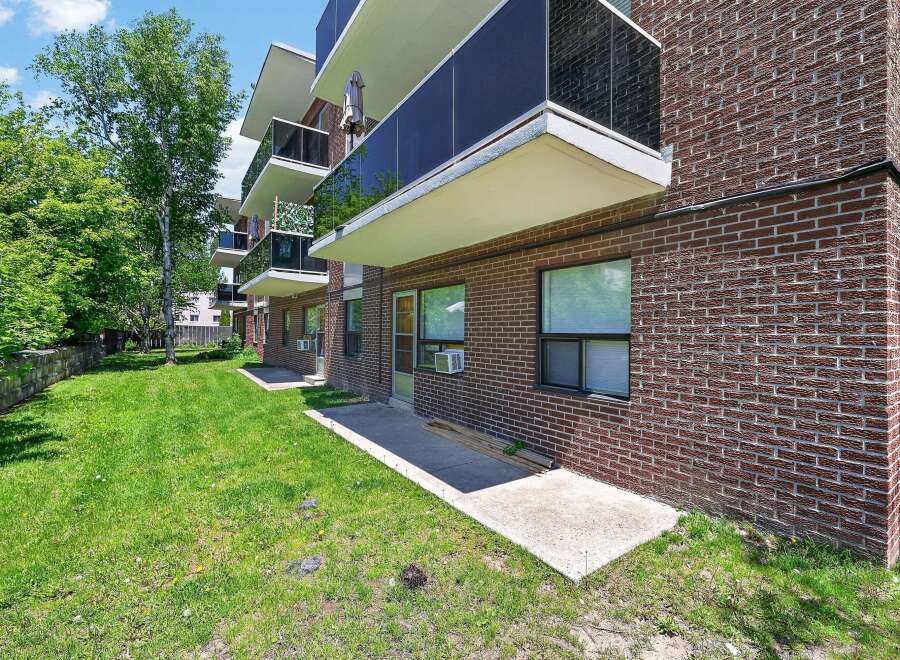 Discover comfortable living in this brick apartment building, featuring private balconies with sleek glass railings perfect for enjoying the outdoors.