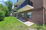 Discover comfortable living in this brick apartment building, featuring private balconies with sleek glass railings perfect for enjoying the outdoors.