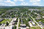 Discover this charming residential neighborhood with a mix of single-family homes and apartment buildings, nestled amidst lush greenery and mature trees.
