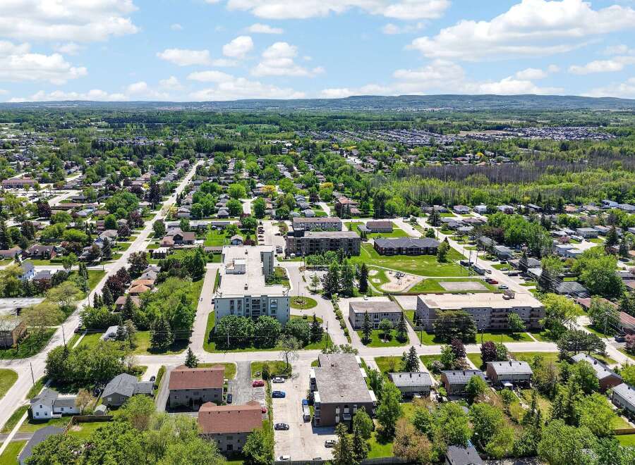 Discover this charming suburban neighborhood featuring a mix of single-family homes and apartment buildings, perfect for families and professionals alike.