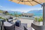 Experience breathtaking lake and mountain views from this stunning terrace, perfect for al fresco dining or relaxing with a book.