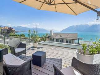 Experience breathtaking lake and mountain views from this stunning terrace, perfect for al fresco dining or relaxing with a book.