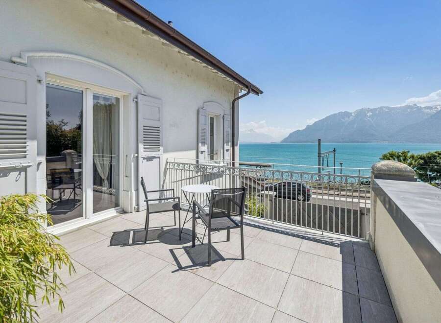 Enjoy breathtaking lake and mountain views from this stunning balcony, perfect for al fresco dining or morning coffee.