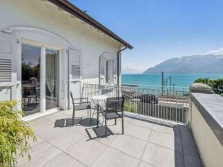 Enjoy breathtaking lake and mountain views from this stunning balcony, perfect for al fresco dining or morning coffee.