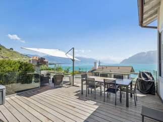 Enjoy breathtaking lake and mountain views from this stunning outdoor living space.
