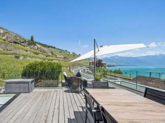 Experience breathtaking lake and mountain views from this stunning outdoor living space, perfect for entertaining or relaxing.