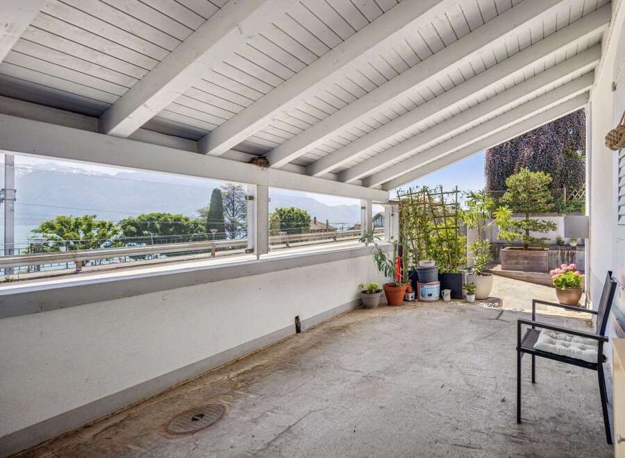 Enjoy breathtaking lake and mountain views from this covered patio, perfect for al fresco dining or relaxing.