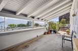 Enjoy breathtaking lake and mountain views from this covered patio, perfect for al fresco dining or relaxing.